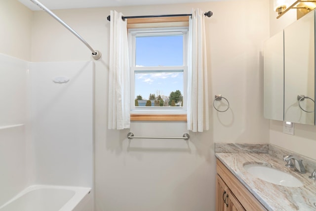 full bath featuring vanity and tub / shower combination