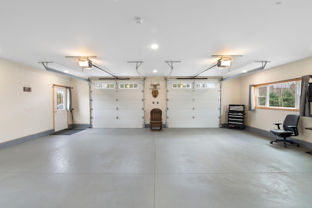 garage featuring recessed lighting, baseboards, and a garage door opener