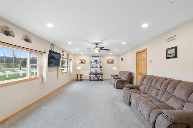 living room featuring baseboards, recessed lighting, and light colored carpet