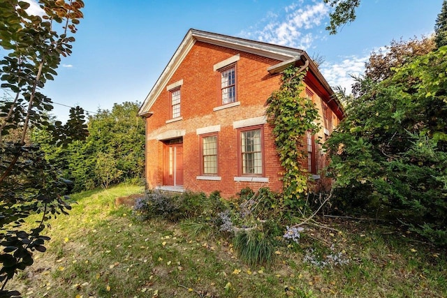 view of side of property featuring brick siding