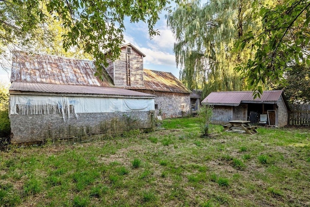 exterior space featuring an outbuilding and metal roof