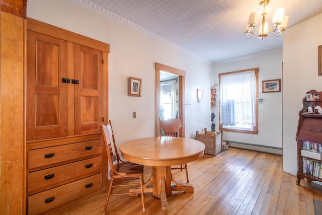 dining room with a baseboard radiator, light wood-type flooring, ornamental molding, and a notable chandelier