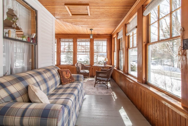 sunroom with wood ceiling, wood walls, a healthy amount of sunlight, and hardwood / wood-style floors
