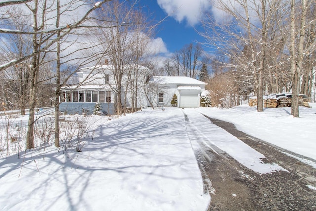 snowy yard with a sunroom