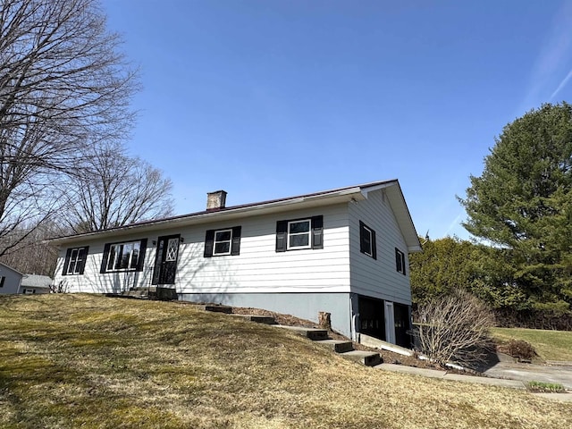 ranch-style home with a chimney and a front lawn