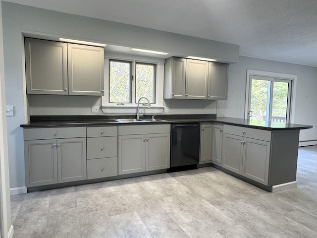 kitchen with gray cabinets, a peninsula, black dishwasher, and a sink