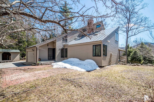 34 Ridge Rd, Jackson, NH 03846 - view of front facade with an attached garage, a chimney, and driveway