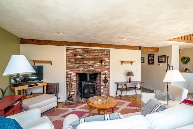34 Ridge Rd, Jackson, NH 03846 - living room with baseboard heating, a wood stove, beamed ceiling, wood finished floors, and a textured ceiling