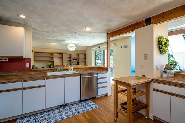 34 Ridge Rd, Jackson, NH 03846 - kitchen with dishwasher, a sink, wooden counters, white cabinetry, and a textured ceiling