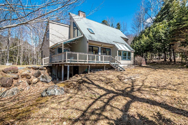 34 Ridge Rd, Jackson, NH 03846 - back of house with a chimney, a deck, and roof with shingles