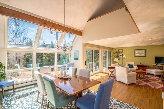 34 Ridge Rd, Jackson, NH 03846 - dining area with high vaulted ceiling, wood-type flooring, and a chandelier