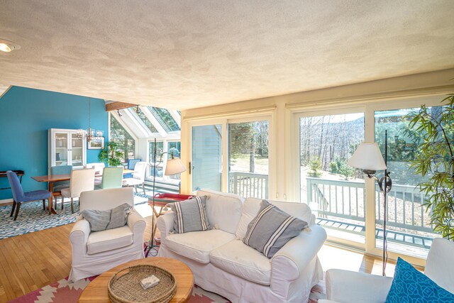 34 Ridge Rd, Jackson, NH 03846 - living room with a textured ceiling, a chandelier, and wood-type flooring