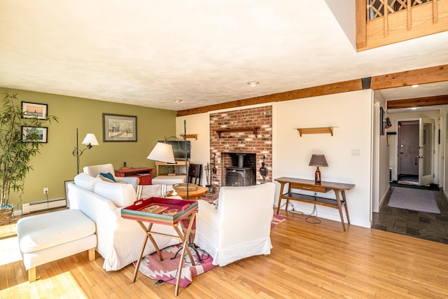34 Ridge Rd, Jackson, NH 03846 - living area featuring baseboard heating, hardwood / wood-style flooring, a wood stove, and baseboards