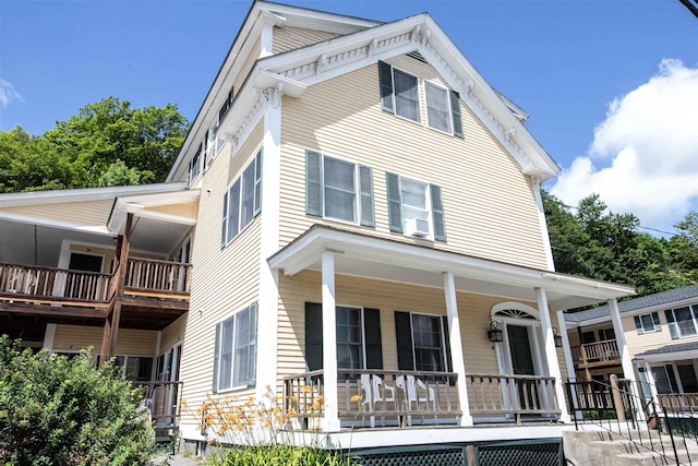 30 Pond St Unit 11, Ludlow, VT 05149 - view of front of property featuring cooling unit and covered porch