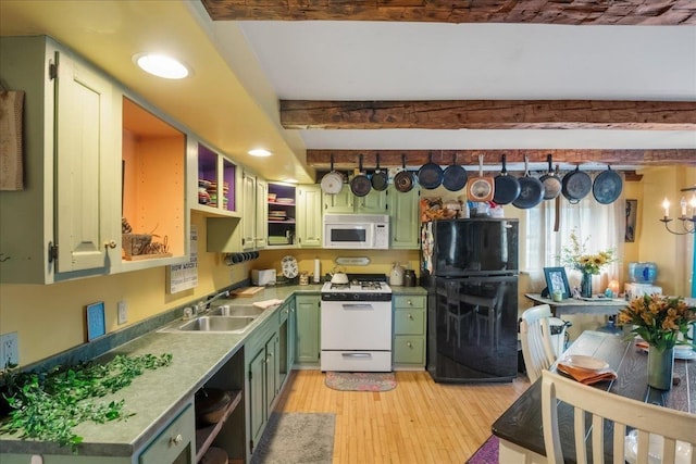 kitchen featuring a sink, white appliances, beamed ceiling, light wood-style flooring, and green cabinetry