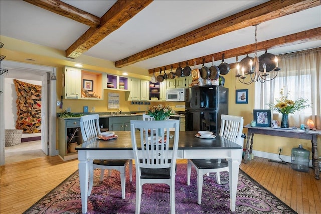 dining space with baseboards, an inviting chandelier, beam ceiling, and light wood-style flooring