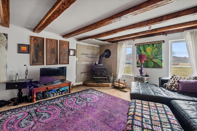 living room with beam ceiling and a wood stove