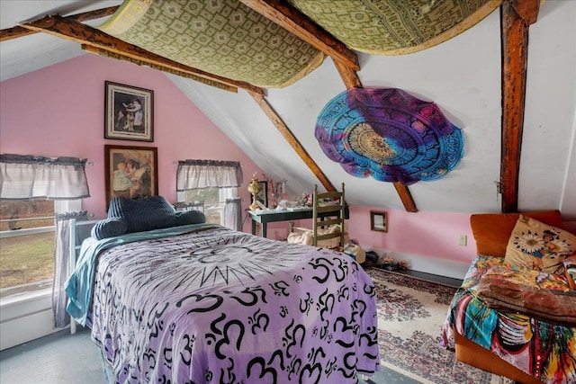 bedroom with lofted ceiling and multiple windows