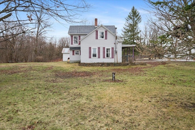 view of side of home featuring a lawn and a chimney