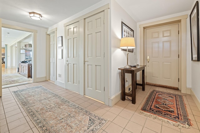 entryway with tile patterned flooring and baseboards