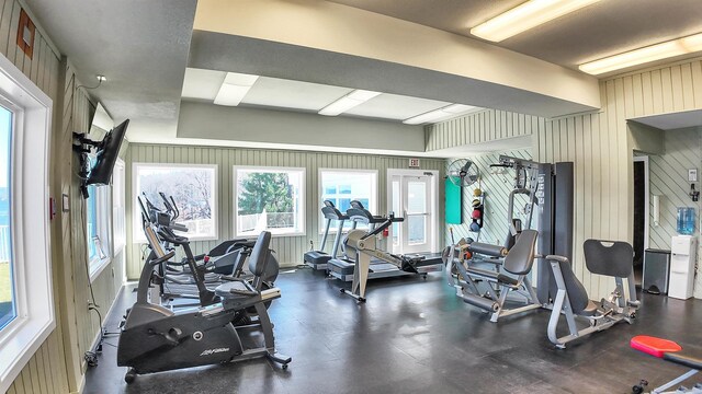 exercise room featuring wood walls