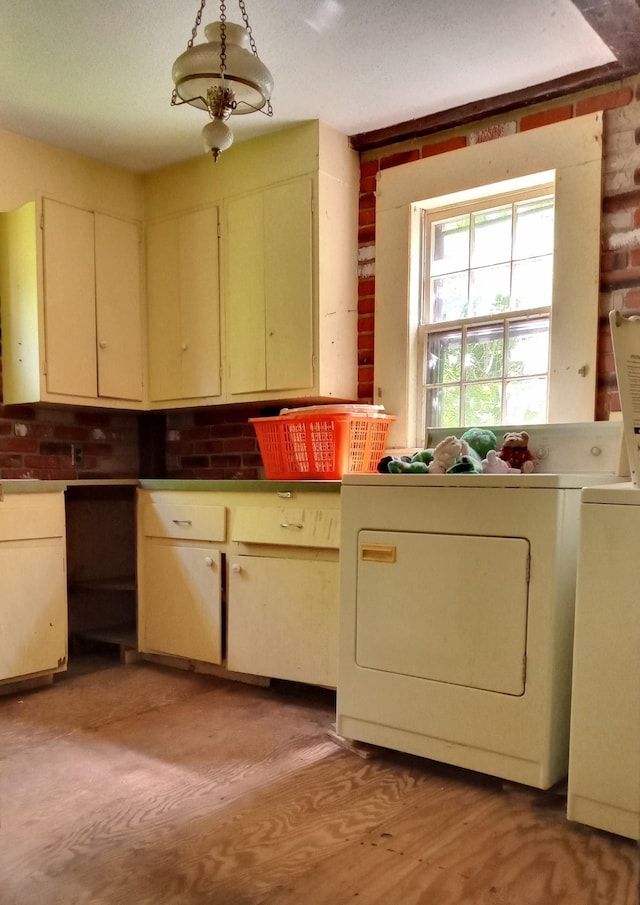 113 Conversevillle Rd, Rindge, NH 03461 - kitchen with washer and clothes dryer and cream cabinets