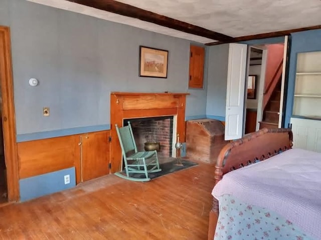 113 Conversevillle Rd, Rindge, NH 03461 - bedroom with wood finished floors and a fireplace with flush hearth