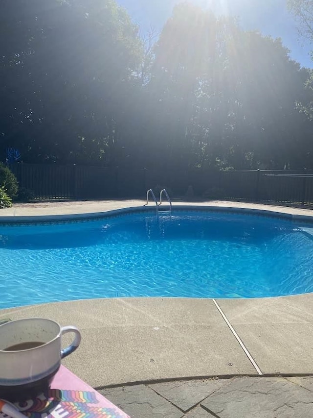 view of swimming pool featuring fence and a fenced in pool