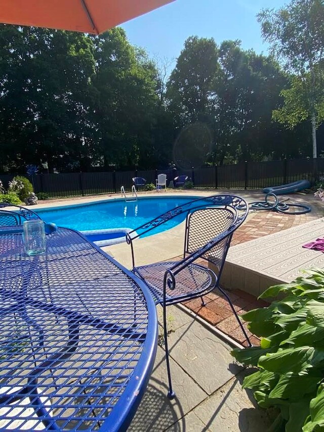 view of pool with fence, a fenced in pool, and a patio