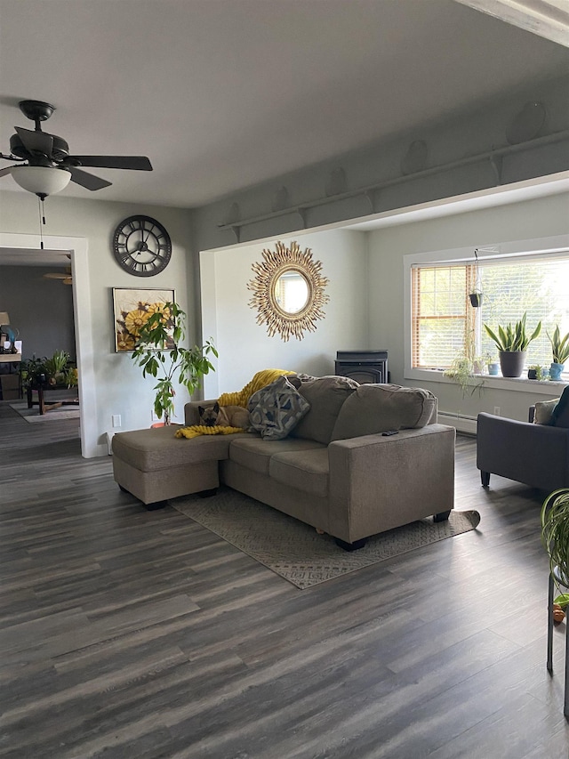 living area featuring a baseboard heating unit, ceiling fan, and wood finished floors