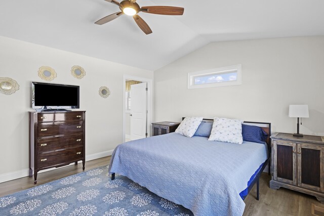 bedroom with lofted ceiling, baseboards, and wood finished floors