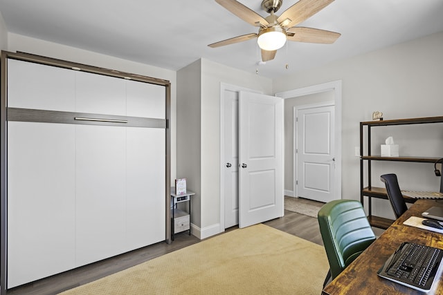 office featuring baseboards, a ceiling fan, and wood finished floors