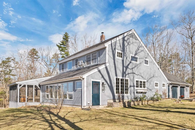 back of property featuring a chimney, a sunroom, and a yard