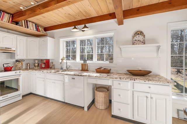 kitchen featuring beamed ceiling, tasteful backsplash, light wood-style flooring, and white appliances