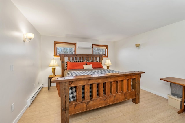bedroom featuring a baseboard radiator, baseboards, light wood-style flooring, and a wall unit AC