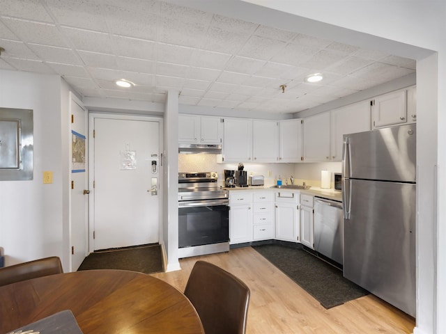 kitchen featuring white cabinets, appliances with stainless steel finishes, and a sink