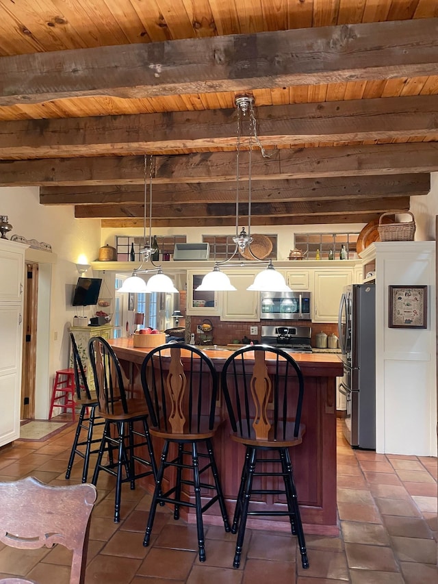 tiled dining room featuring beamed ceiling and wood ceiling