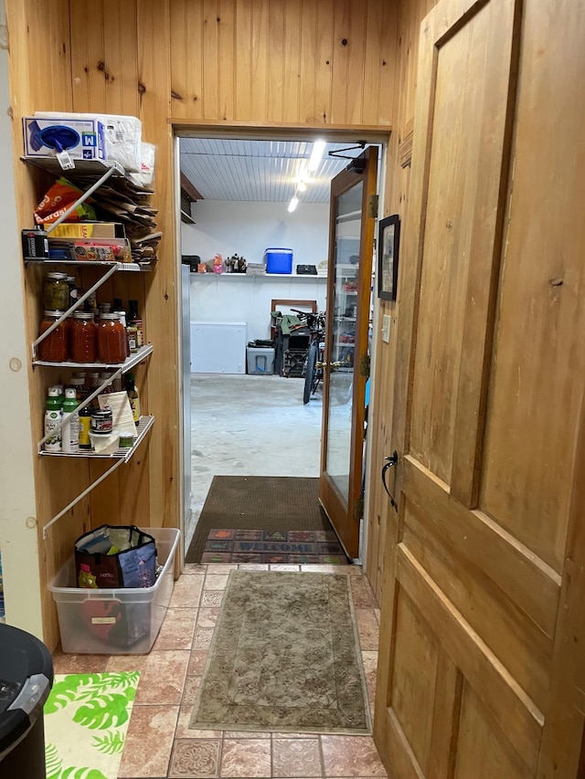 entryway with wood walls