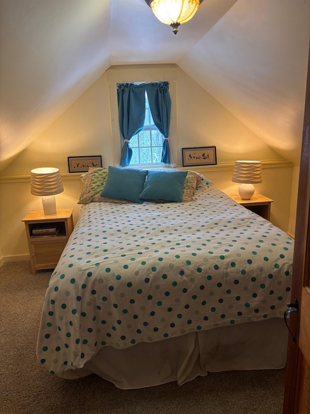 bedroom featuring vaulted ceiling and carpet floors