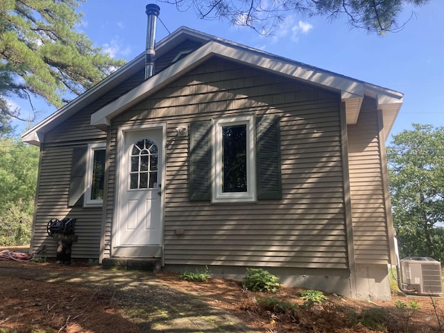 rear view of property featuring central AC