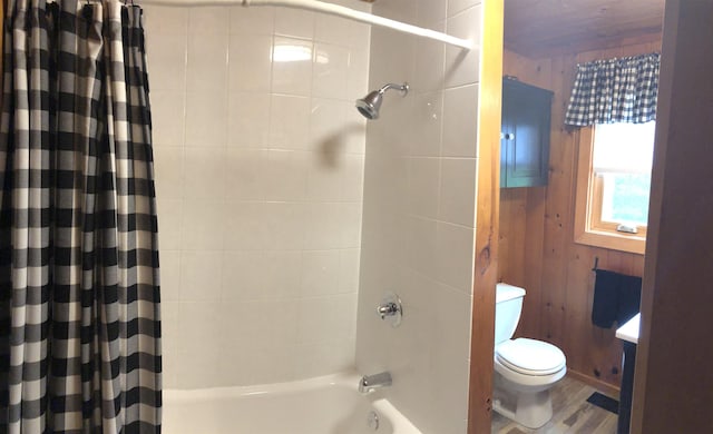 full bathroom with shower / tub combo, toilet, wood walls, and wood finished floors