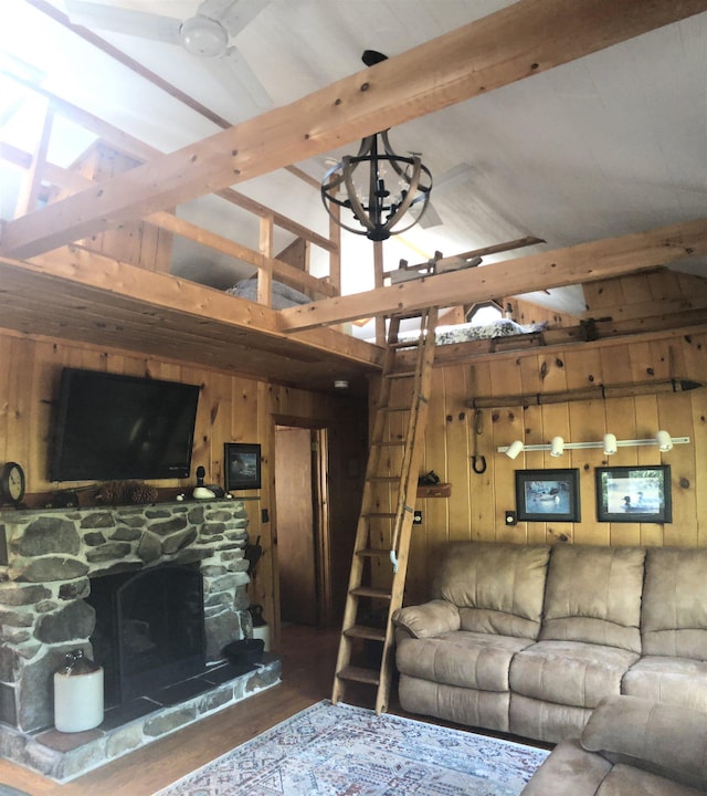 living room with high vaulted ceiling, wood walls, wood finished floors, and beamed ceiling