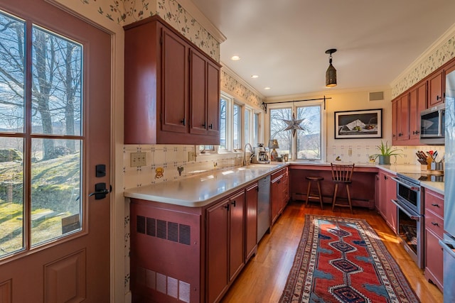 3360 Dorset W Rd, Dorset, VT 05251 - kitchen with light wood finished floors, stainless steel appliances, a sink, and tasteful backsplash