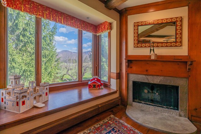 3360 Dorset W Rd, Dorset, VT 05251 - sitting room featuring a high end fireplace, a mountain view, beam ceiling, and wood finished floors