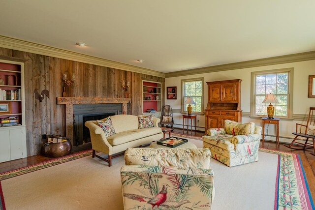 3360 Dorset W Rd, Dorset, VT 05251 - living room featuring wooden walls, ornamental molding, baseboard heating, a fireplace, and built in shelves