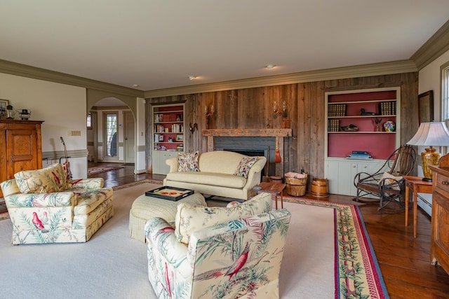 3360 Dorset W Rd, Dorset, VT 05251 - living room featuring wood finished floors, arched walkways, a fireplace, wood walls, and ornamental molding