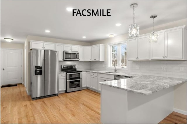 102 Laurel Rd Unit 30, Hooksett, NH 03106 - kitchen featuring appliances with stainless steel finishes, a peninsula, a sink, white cabinetry, and recessed lighting