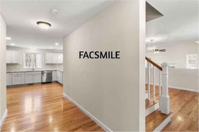 102 Laurel Rd Unit 30, Hooksett, NH 03106 - hallway with a sink, a chandelier, light wood finished floors, baseboards, and recessed lighting