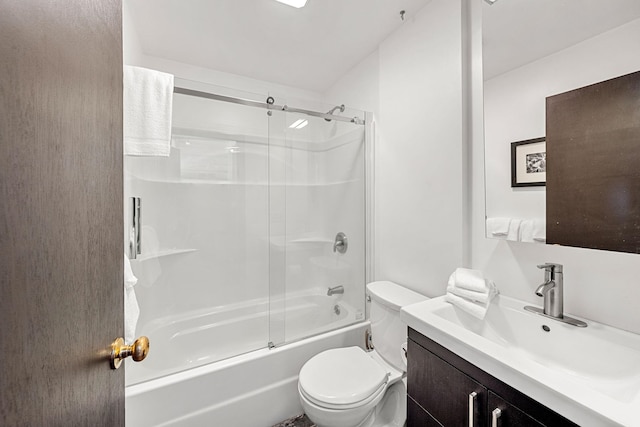 full bathroom with enclosed tub / shower combo, toilet, and vanity