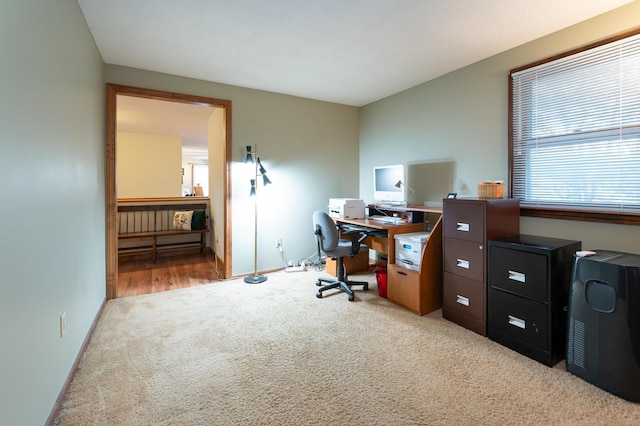 carpeted office space featuring baseboards